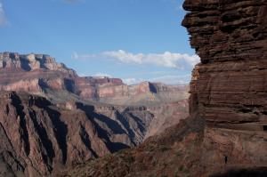 An image of the Grand Canyon from a hiker within the formation against a blue sky