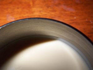 Milk in a ceramic mug on a wooden table