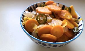 small bowl with blue pattern filled with sliced carrots, onions and jalapenos
