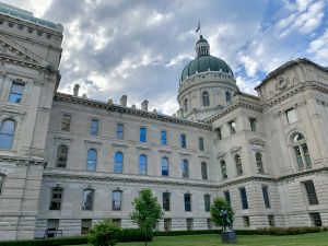 The Indiana Statehouse. It's a large tan building with a green dome.