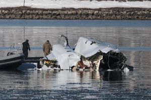 First responders search the crash site of American Airlines flight 5342 along the Potomac River near Ronald Reagan National Airport in Arlington, Va., on Thursday.