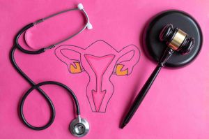 Drawing of female reproductive system with judge's gavel and stethoscope. Conceptual about abortion legislation
