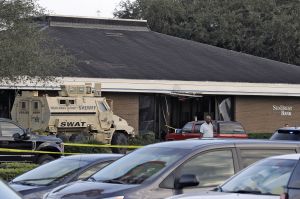 OK A Highlands County Sheriff's SWAT vehicle is stationed out in front of a SunTrust Bank branch, Wednesday, Jan. 23, 2019, in Sebring, Fla., where authorities say five people were shot and killed
