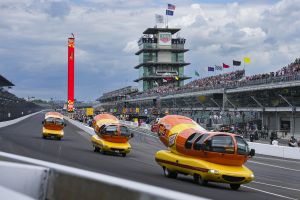 The Oscar Mayer Wienermobiles head into the first turn as they compete in the Wienie 500 following the practice session for the Indianapolis 500 auto race at Indianapolis Motor Speedway in Indianapolis, Friday, May 23, 2025. (AP Photo/Michael Conroy)