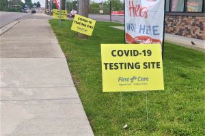 Signs outside of a coronavirus testing facility in Bloomington.