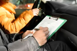 Instructor conducting driver license test, stock image