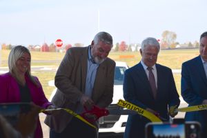  Gov. Eric Holcomb and other state officials cut the ribbon on a new scenario-based training village at the Indiana Law Enforcement Training Academy