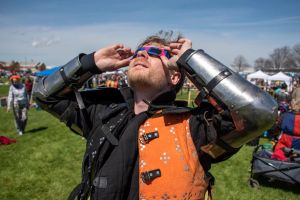 Performers dressed in full armor took a break from combat exhibitions to don modern protective glasses and gaze at the sun during the total solar eclipse on Monday.