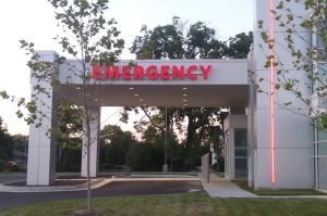 A sign on the entrance to a building reads &amp;quot;Pharmacy&amp;quot; in red, block letters.