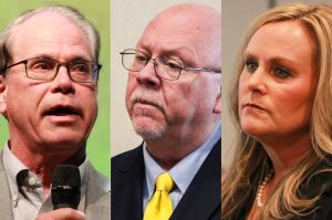 Three separate images put together, of Mike Braun, Donald Rainwater and Jennifer McCormick. Braun is a White man with dark, graying hair. He is wearing glasses and holding a microphone. Rainwater is a White man, bald, with a white goatee. He is weari