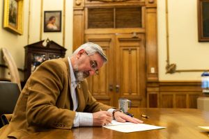 Indiana Gov. Eric Holcomb signs bills into law in a photo taken March 7, 2022.