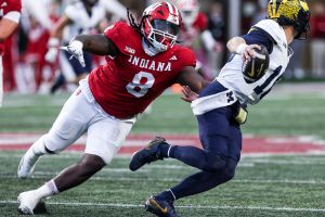 Indiana's CJ West chases after Michigan quarterback Davis Warren during Saturday's game at Memorial Stadium.