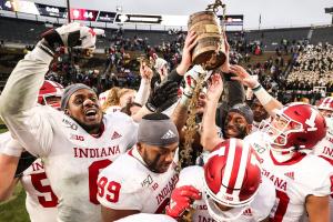 Indiana players celebrate with the Old Oaken Bucket after defeating Purdue on Nov. 30, 2019, in West Lafayette 