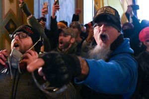 Schaffer is seen wearing an “Oath Keepers Lifetime Member” hat at the Capitol in a photo submitted to the United States Department of Justice for his arrest. 