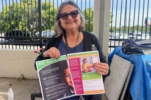 Maryori Duarte-Sheffield, a health educator for the Marion County Public Health Department holds up lead exposure resources at an immigration fair.