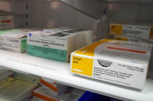 Vials of the MMR measles mums and rubella virus vaccine sit in a refrigerator with other medicine