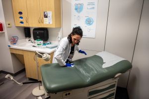 Shira Klane, a nurse practitioner who works in Planned Parenthood clinics across Minnesota, cleans an exam room in the Mankato clinic where she is working for the day to fill some vacancies.