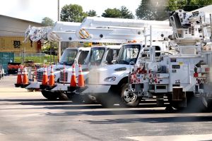 Duke Energy trucks are lined up at the company building on West Second Street.