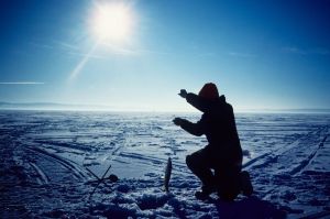 Ice fishing, blue sky, sun getting low