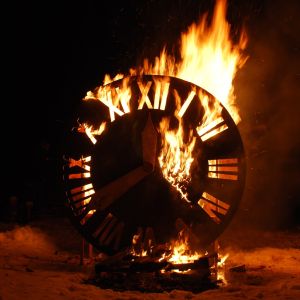 giant wooden clock burning in a bonfire