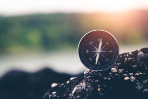Compass sitting on rock.