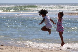 Girls jumping at the seashore