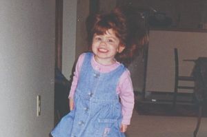 Little girl running down a hallway.