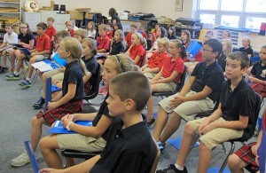 Students sing and play music games during choir class at St. Charles Catholic School in Bloomington.
