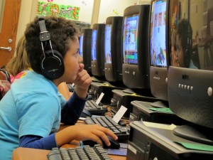 A student at Crawfordsville's Hose Elementary uses a computer in the school's media center. The district has zeroed out its technology fund and made other cuts to make up for revenues they lost because of Indiana's property tax caps.