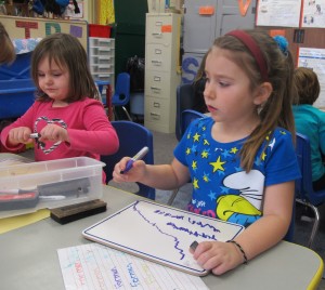 A Head Start student at Eastview Elementary in Connersville draws on a white board.