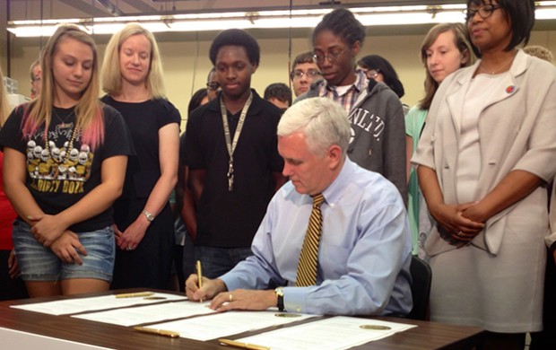 Gov. Mike Pence, during an event at Warren Central High School in Indianapolis,  signs an executive order creating the Center for Education & Career Innovation.