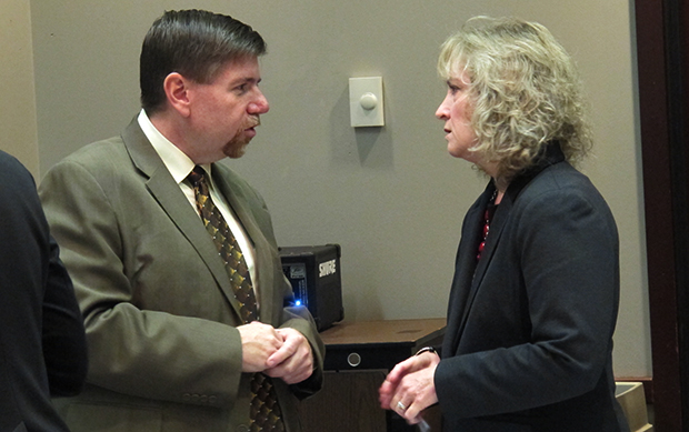 State superintendent Glenda Ritz speaks to State Board of Education member Brad Oliver after returning from a recess during which her staff and representatives of the Center for Education and Career Innovation hashed out a motion for the panel to approve a conceptual framework for a new A-F grading system.