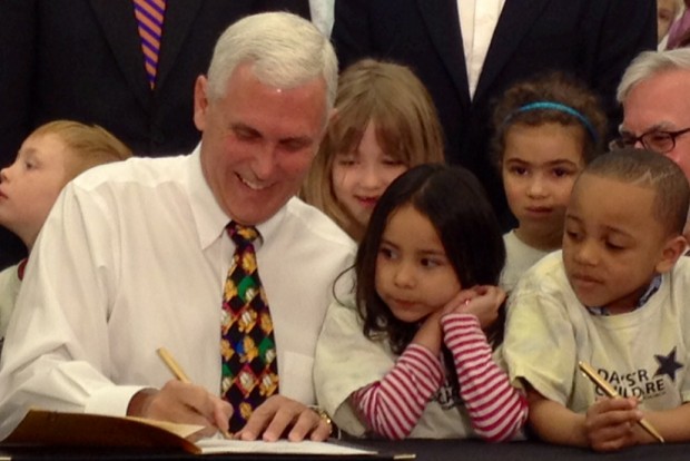 In this 2014 photo Gov. Mike Pence signs legislation creating a state-funded preschool pilot program. (Brandon Smith/Indiana Public Broadcasting)