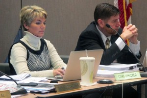 State Board members Cari Whicker, left, and Brad Oliver listen during a presentation on new social studies standards.