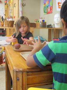 Students at Busy Bees Academy in Columbus use clay during free time. 
