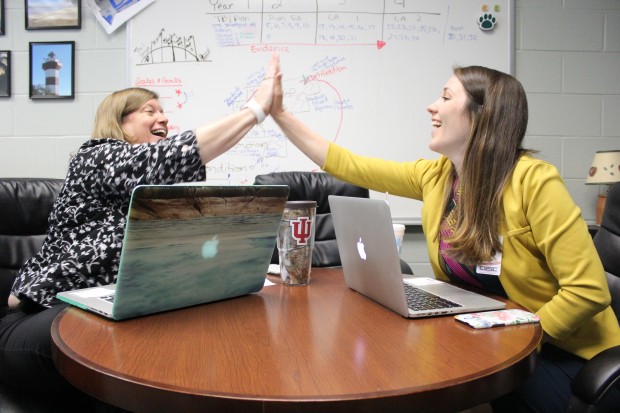 Principal Helene Blum and Director of School Transformation Kelsey Wright hi-five during one of Wright's weekly check-ins. (Peter Balonon-Rosen/StateImpact)
