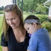 Kendra Bowden and her son Wyatt, 3, on their porch. Wyatt has had cochlear implants for most of his life. (Peter Balonon-Rosen/Indiana Public Broadcasting)
