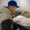 A student studies a sheet with fruits and vegetables in the Indiana Region 4 migrant education center's mobile classroom. (Peter Balonon-Rosen/Indiana Public Broadcasting)