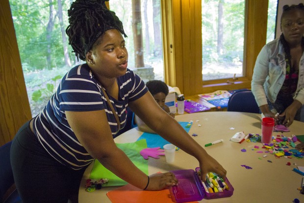 Camper Chandra works on an art project that depicts a chapter of her life. (Peter Balonon-Rosen/Indiana Public Broadcasting)